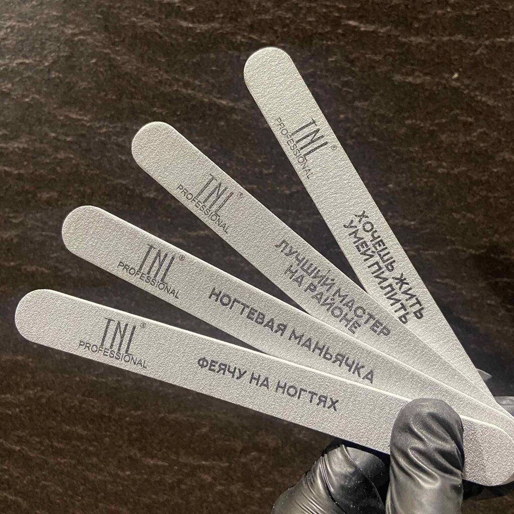 Пилки для ногтей TNL 100/180 Овал с надписями в ассортименте от компании Интернет-магазин BeautyShops - фото 1